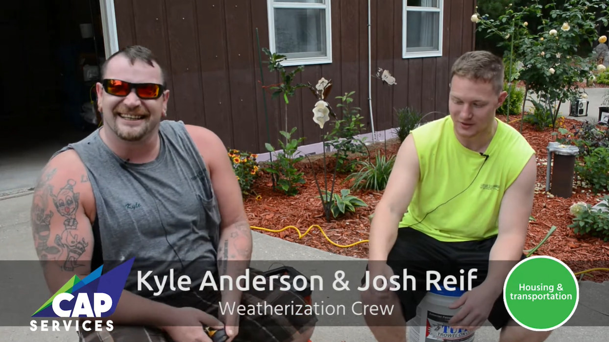 Kyle Anderson and Josh Reif from the CAP Weatherization crew sitting outside